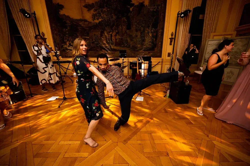 Wedding guests swing dancing on the parquet floor during a Meridian House reception