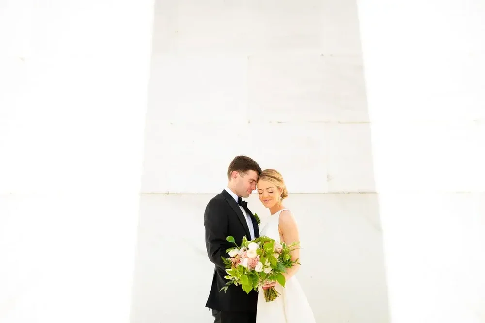 Romantic couple portrait with bouquet on their Meridian House wedding day