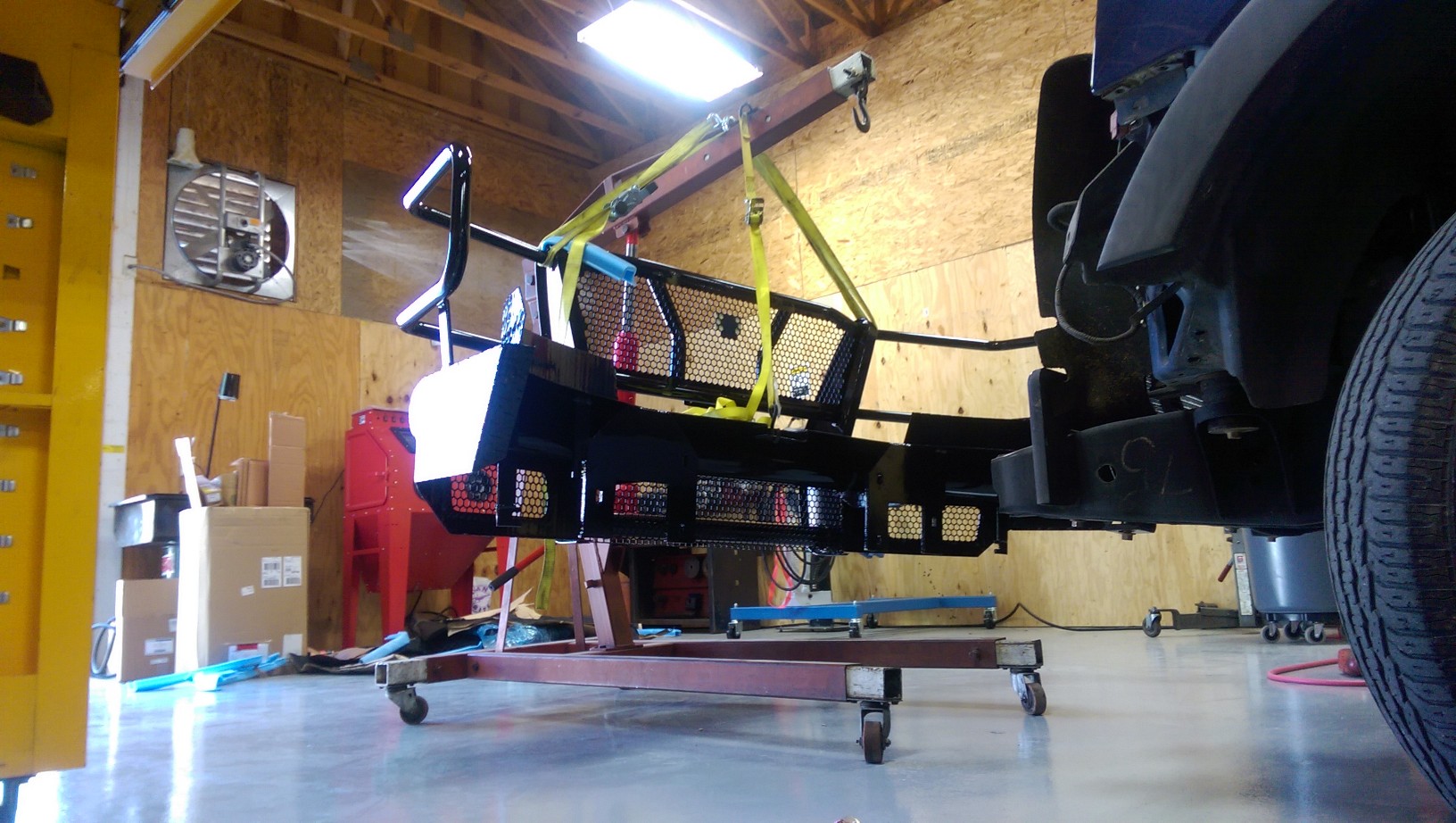 Yes we install aftermarket accessories at Team Ryan Automotive. This is a 220 pound front bumper being picked up with our engine hoist. 