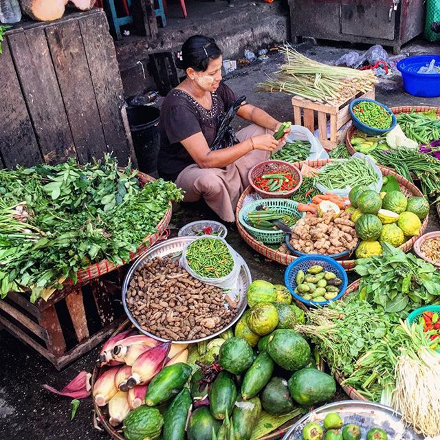 A woman at the market wearing thanaka