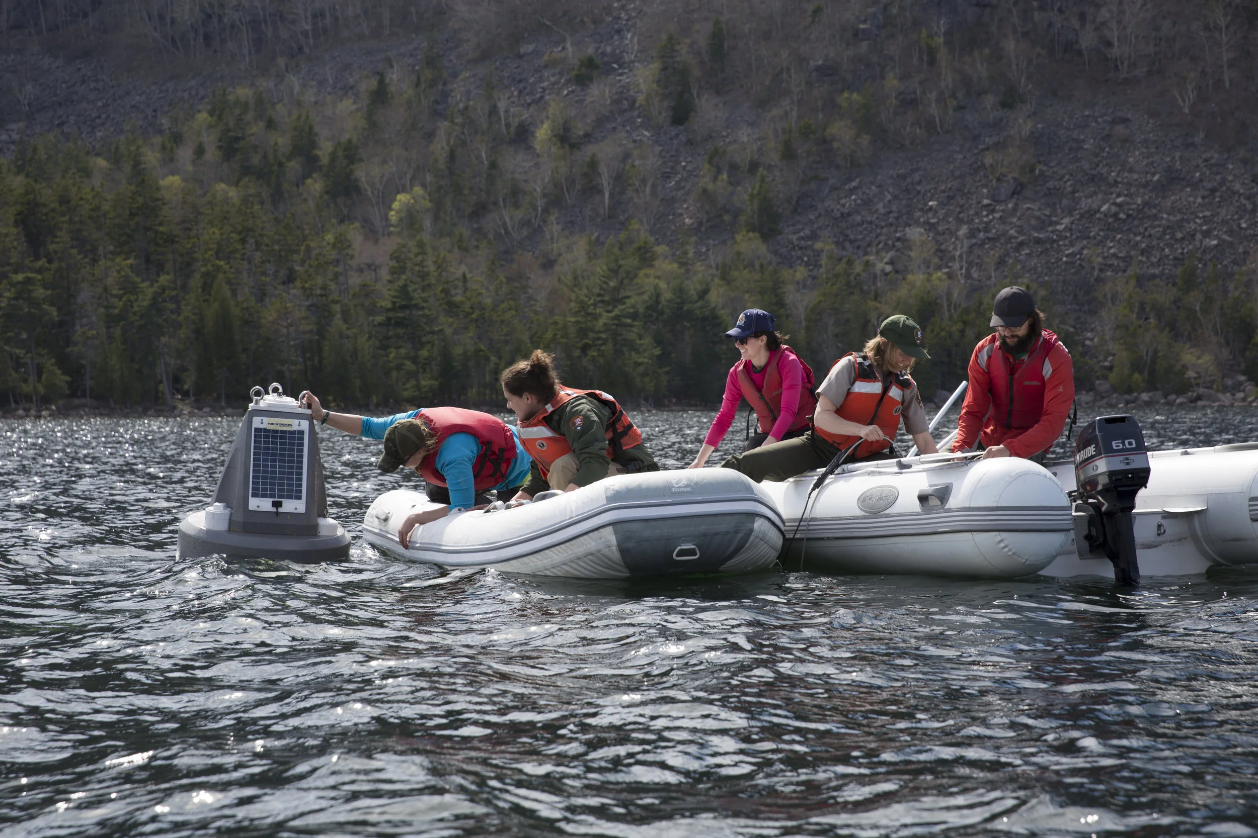 Kate and Shannon have rolled the buoy into the water and are checking its position