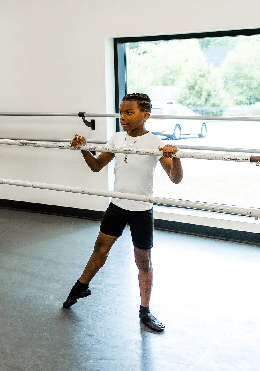A ballet dancer mid-movement, showcasing natural turnout and fluidity