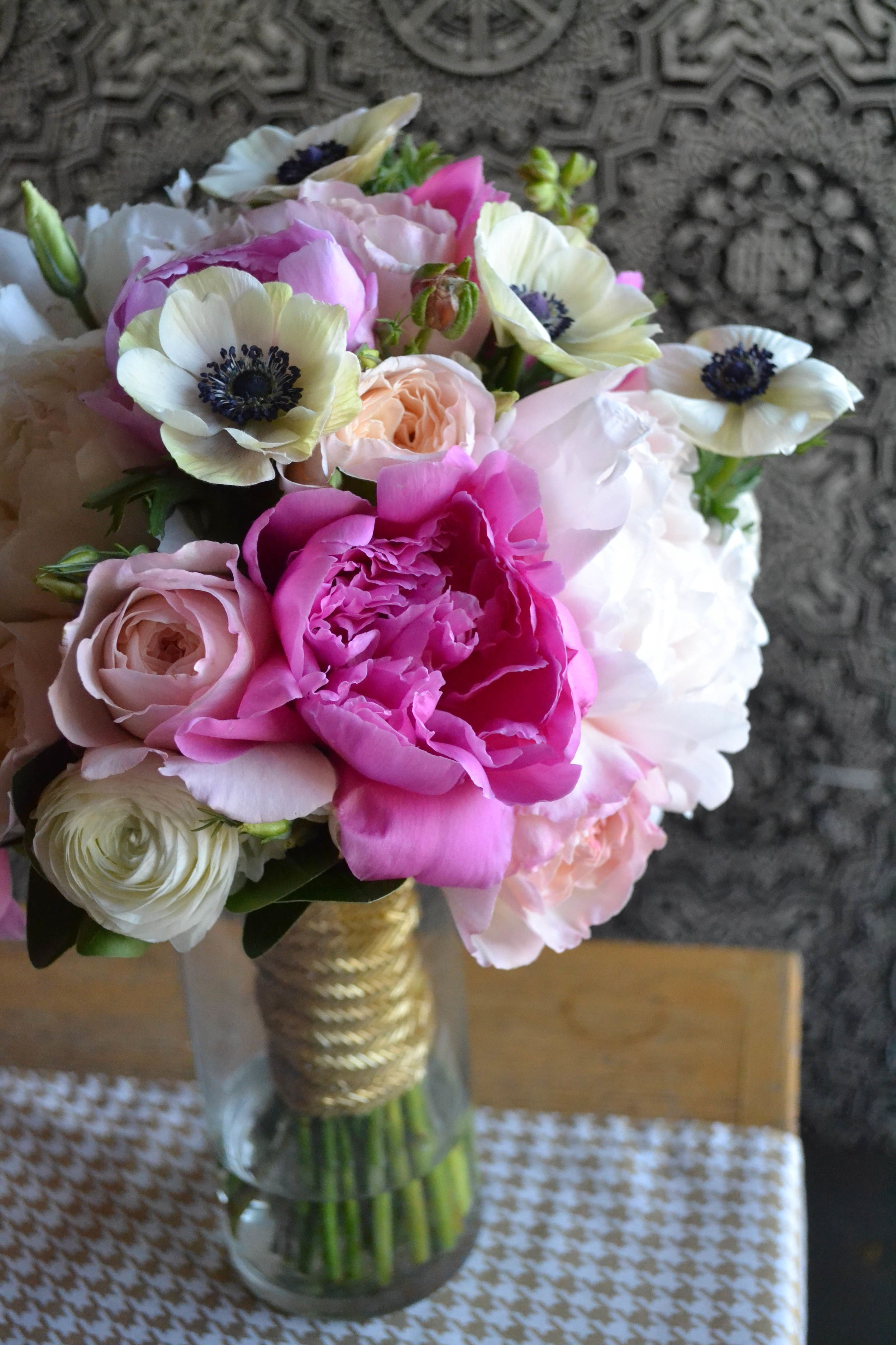 Bridal bouquet of pink and white radunculus and anemones. Rosehip Social, Brooklyn, NY.