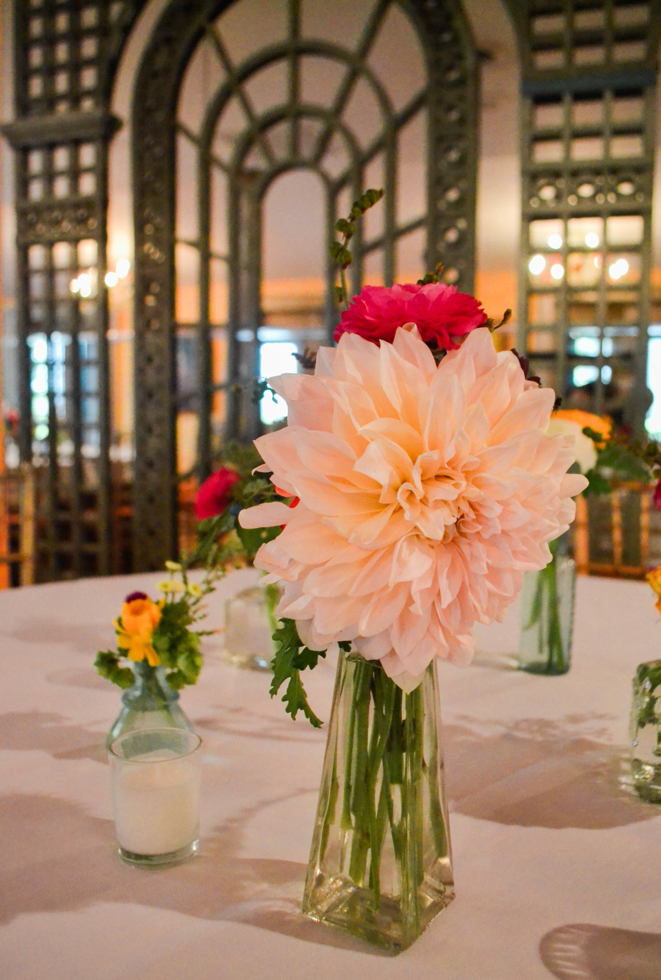Colorful and romantic flower centerpiece in bud vase bottle. Catskills wedding. August.