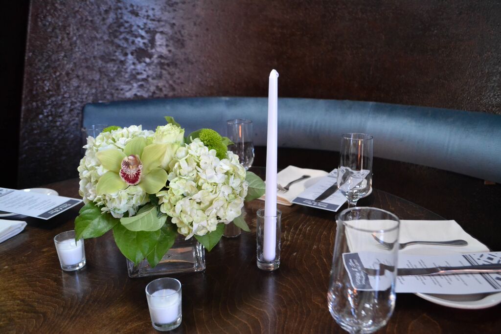 Green Cymbidium orchid and hydrangea centerpieces at MyMoon. Rosehip Social, Brooklyn, NY.