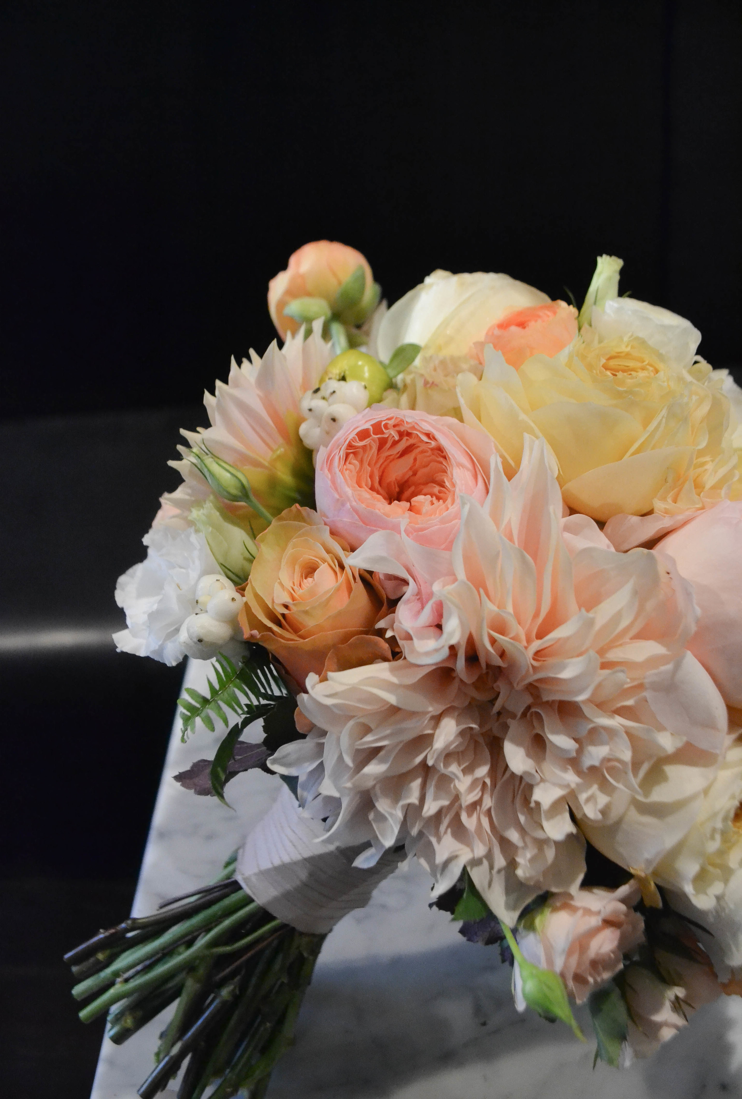 Bridal bouquet including cafe au lait dahlias, garden roses, sahara rose, spray rose and ranunculus. Lush round classic bouquet with faded fall colors. Gramercy Park Hotel Terrace Wedding. Rosehip Social Floral Design. 