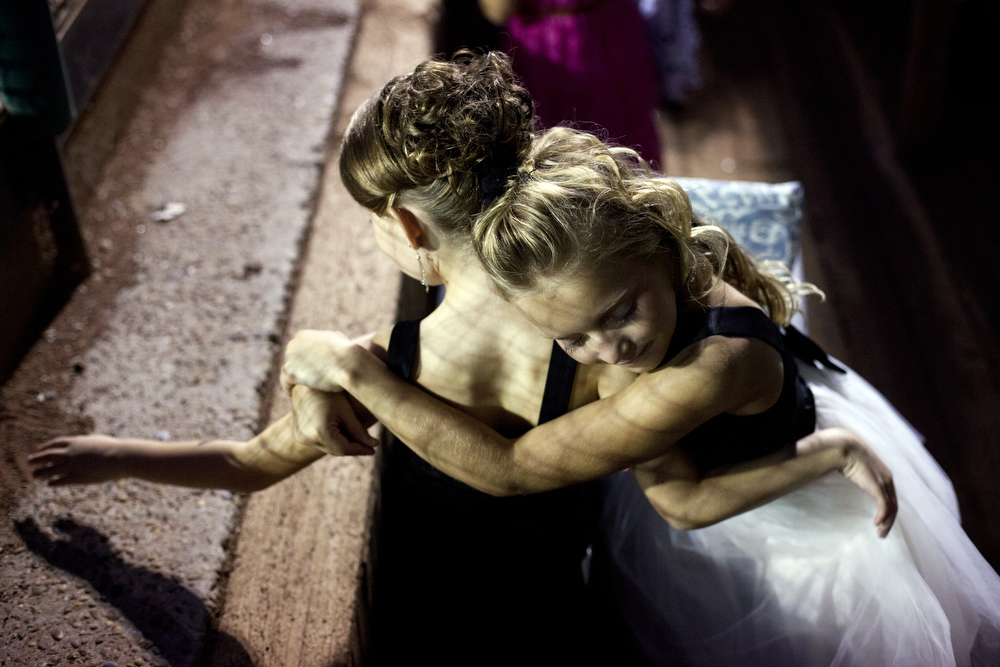  Junior Miss Herbstfest contestant Arrington Hartke hugs fellow contestant Calista Martin, both 8 and of Holland, while the judges deliberated at League Stadium in Huntingburg, Ind. on Sept. 27, 2013. &nbsp;The two girls were the only ones from Holla