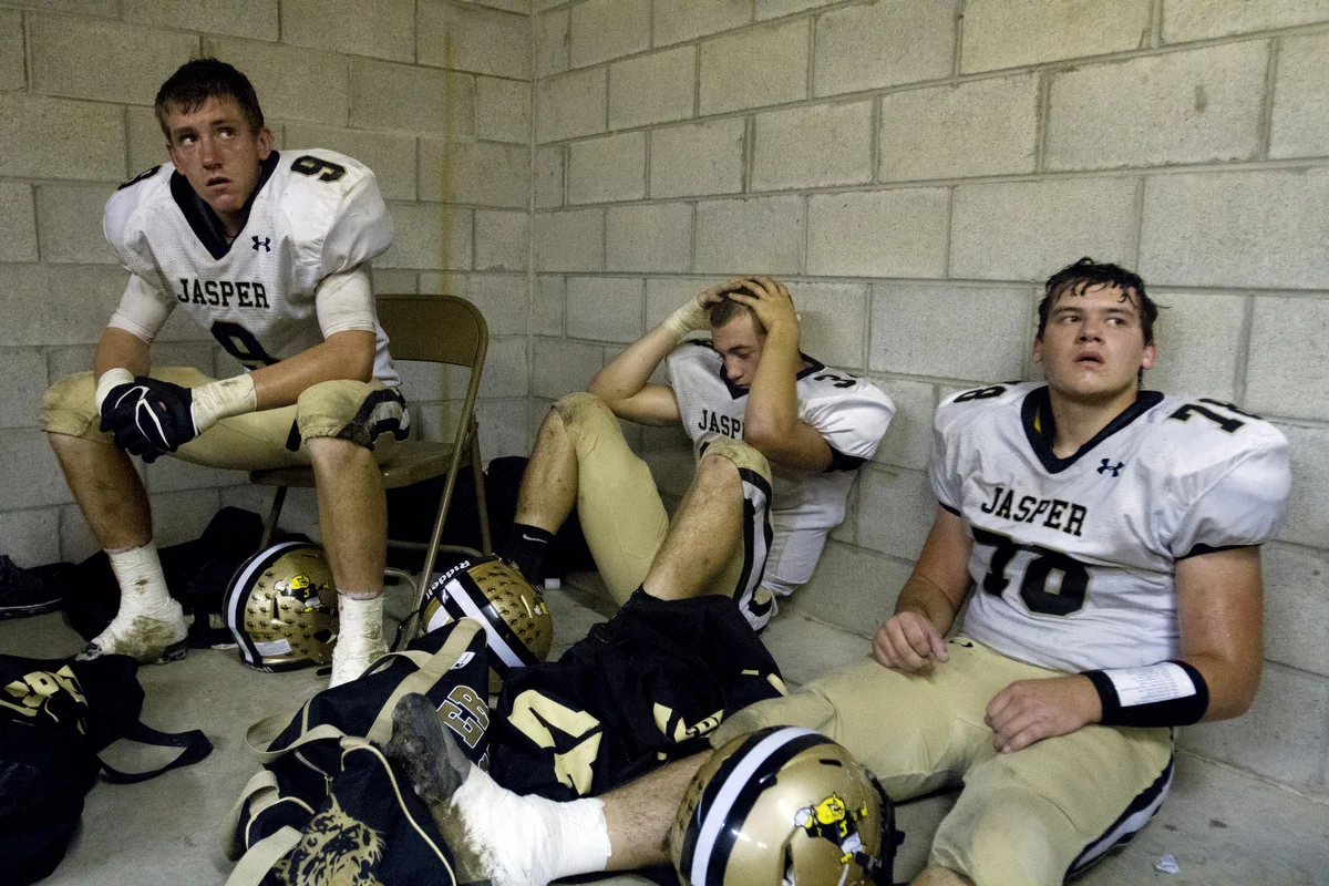  Jasper's Scott Stallwood, left, Cole Kreilein and Dylan Persohn listen to their coaches in the locker room after a disappointing first half of the game against Mount Carmel in Mount Carmel, Ill. on October 4, 2013. &nbsp;Mount Carmel won 27-14. &nbs