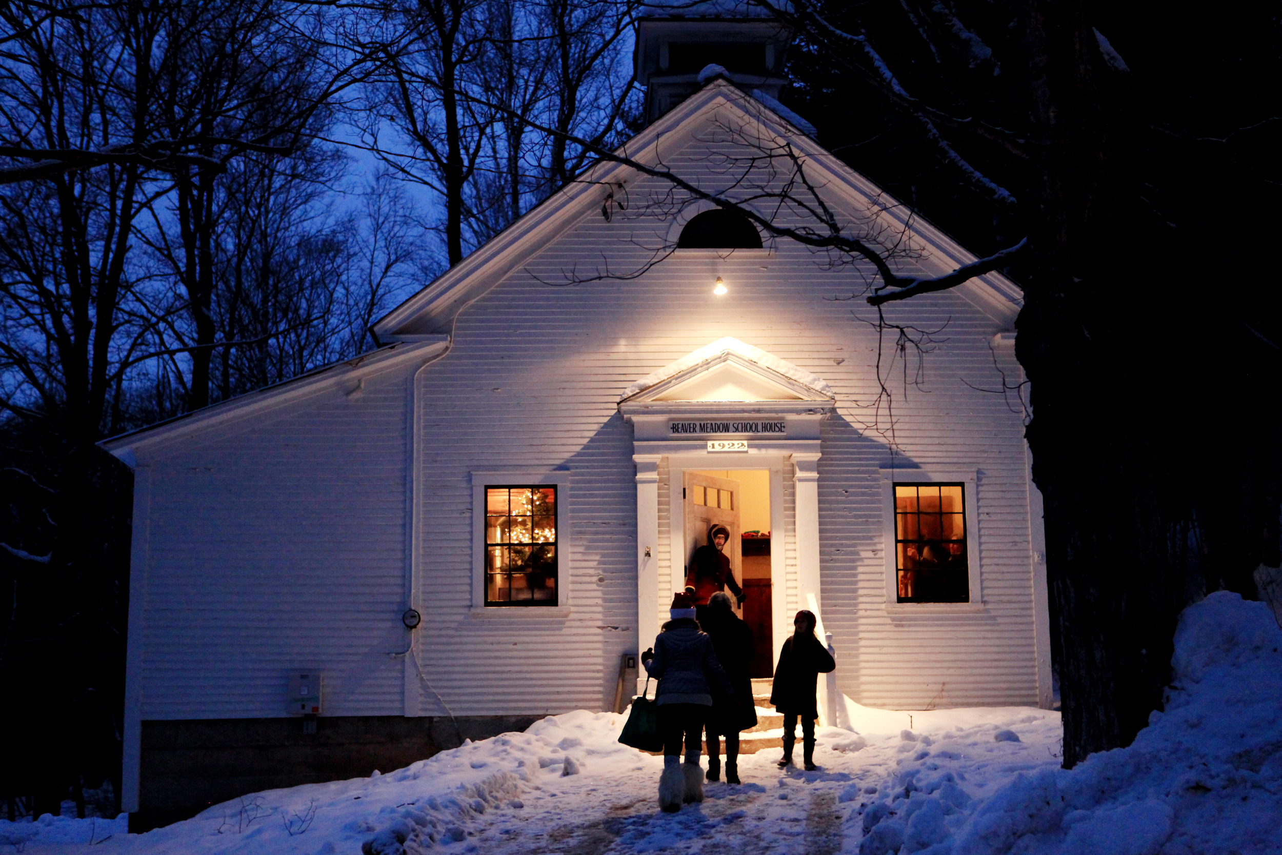  Light from the Beaver Meadow school house in Norwich, Vt.&nbsp;beckons those coming to the holiday service and potluck on Dec. 21, 2014.&nbsp; 