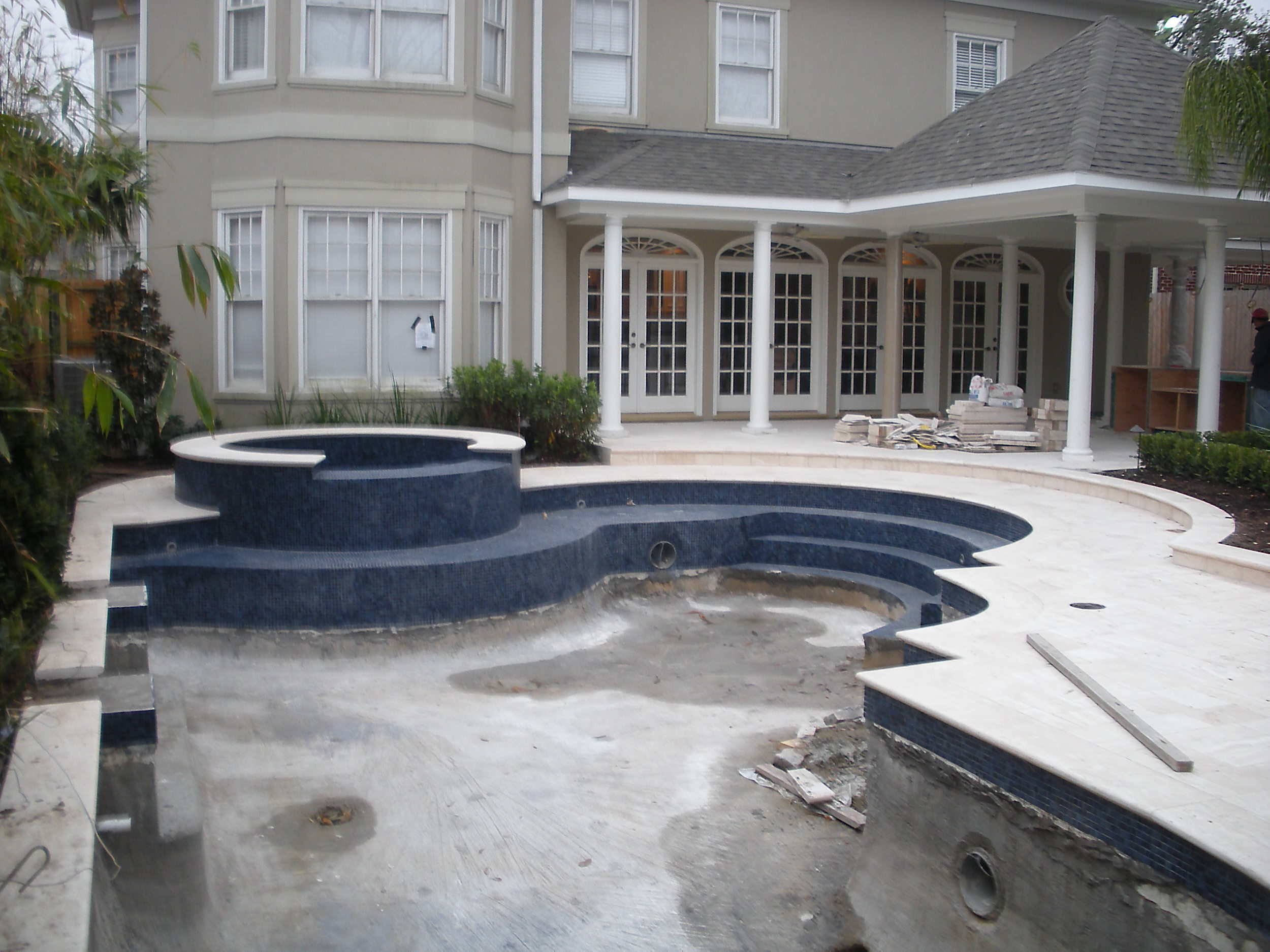 Stone pool decking, coping and water line tile