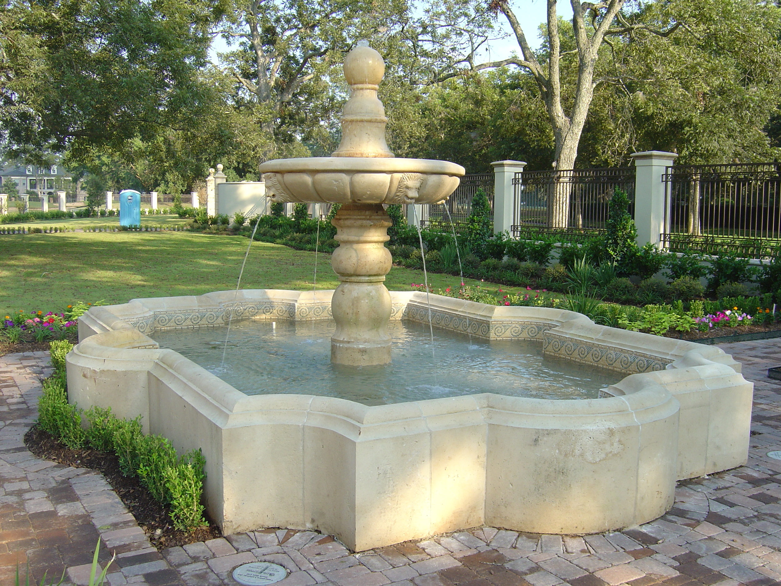 Limestone fountain, water line tile and paver floor