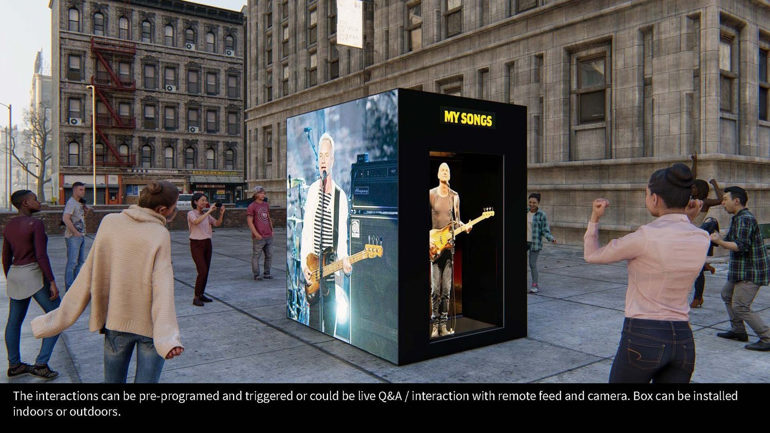 People gathered outdoors around an interactive display exhibit with large screens showing a musician playing guitar, titled 'MY SONGS'.