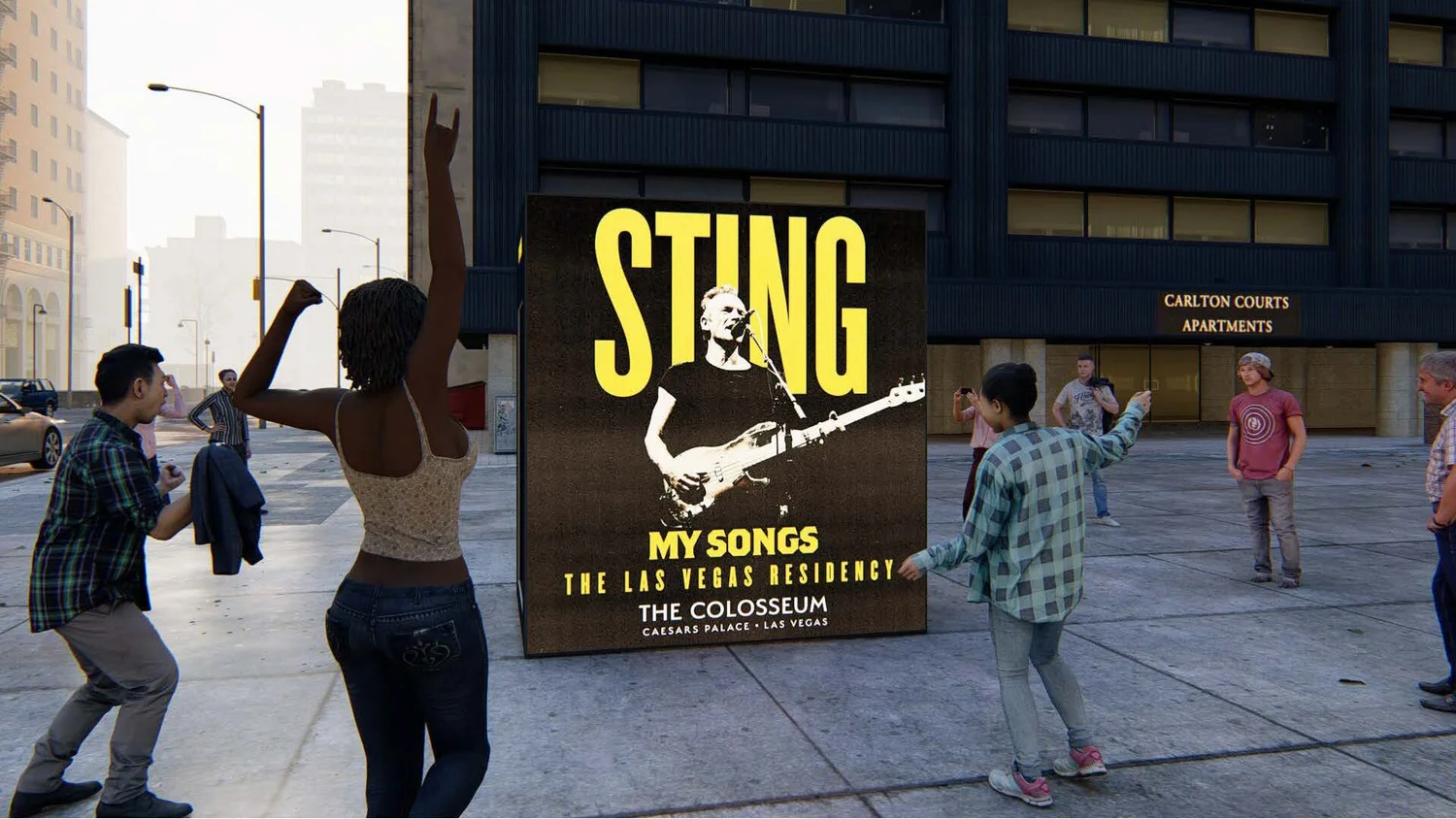 People in a city square taking photos of a large poster advertising Sting's music concert at The Colosseum, Caesars Palace in Las Vegas, with some people dancing and others posing for photos.