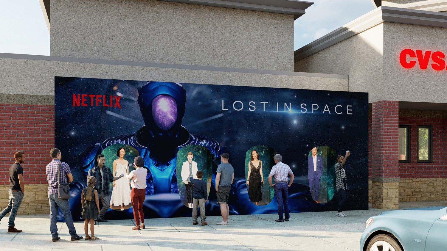 People stand outside a store in front of a large poster for the Netflix series 'Lost in Space,' featuring a space-themed background and characters.
