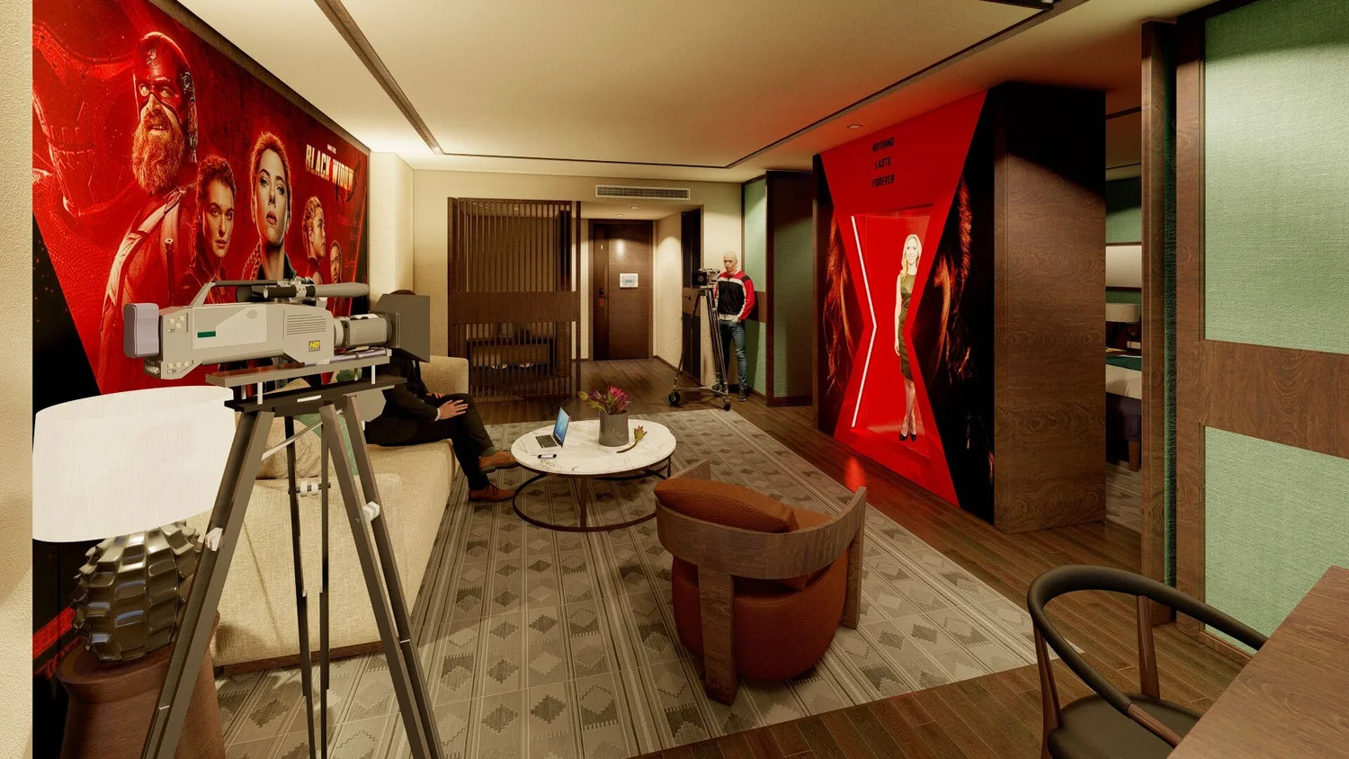 A hotel room or lounge with 'Black Widow' movie posters on the walls, a camera on a tripod, a person sitting on a couch with a laptop, and a man standing next to a film camera. The room has modern decor with a patterned rug, a small round coffee tabl