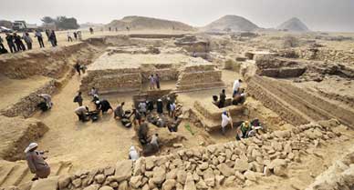 Egyptian archaeologists work at an ancient burial ground in Saqqara, dating back to 2,700 B.C.