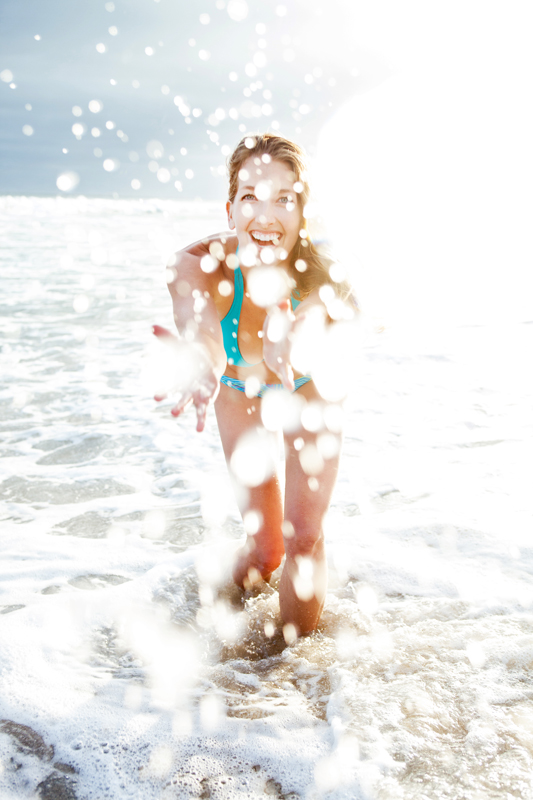 Reef girl splashing in the waves. san diego lifestyle photographer, san diego lifestyle photography, southern California lifestyle photographer, California lifestyle photographer, lifestyle photo