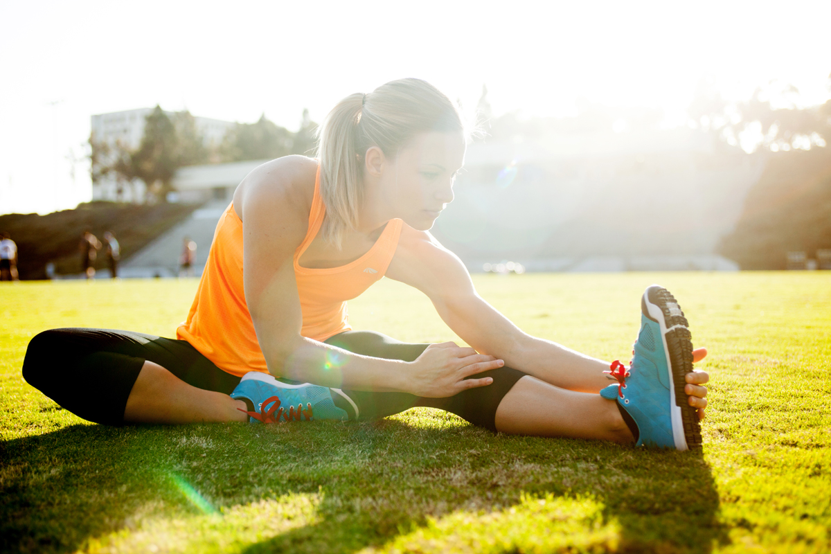 Athletic girl stretching at the track in Nike gear. san diego lifestyle photography, san diego lifestyle photographer, southern California lifestyle photographer, California lifestyle photographer