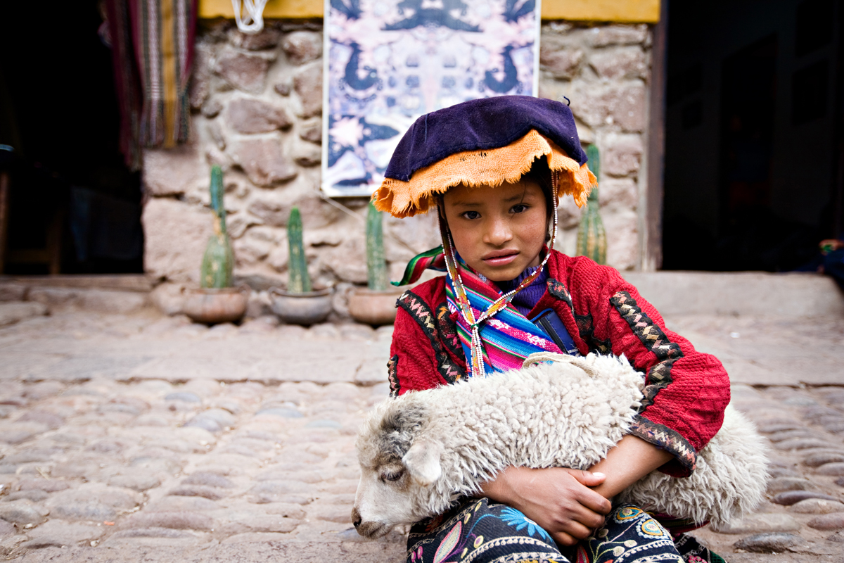 Cute photo of a Peruvian child holding a lamb. san diego travel photography, san diego travel photographer, southern California travel photographer, California travel photographer