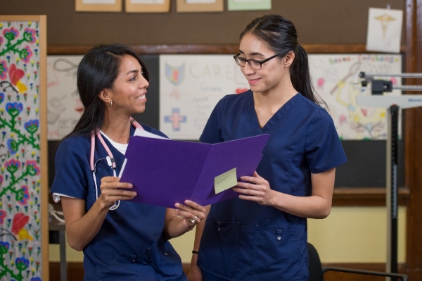Genesis graduate Adry Mijares, left, and classmate Natalie Eche.