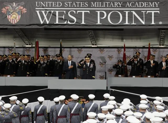 President Barack Obama and Lt. Gen. Robert Caslen Jr. , center, superintendent at the U.S. Military Academy, stand for the national anthem during last week’s graduation and commissioning ceremony in West Point, N.Y. Obama urged restraint before further military missions.