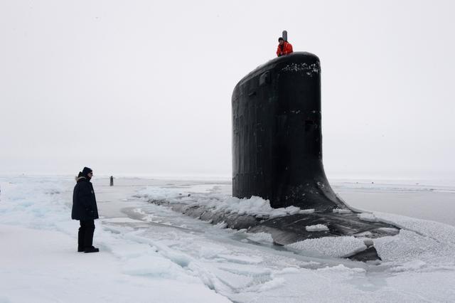 The submarine USS New Mexico surfaces through the ice during a Navy exercise in the Arctic Ocean last month. Scientists predict that Arctic ice could melt enough to allow for commercial shipping year round. The U.S. is one of many countries with claims in the Arctic.