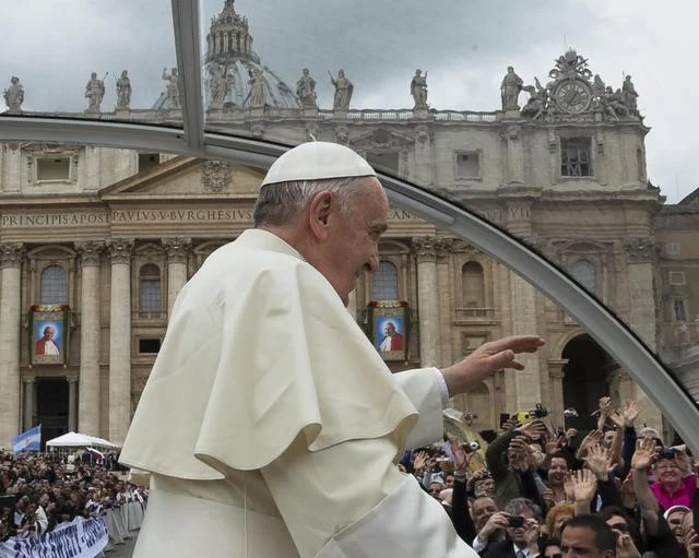 Domenico Stinellis/ The Associated Press Pope Francis is driven through a Vatican crowd Sunday after presiding over a ceremony canonizing two of his predecessors, John XXIII and John Paul II.