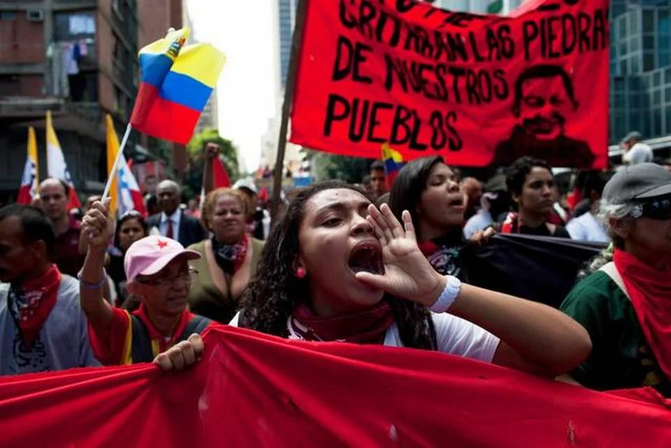 Members of a pro-government “colectivo,” or “collective,” march in downtown Caracas, Venezuela, this year. President Nicolas Maduro and his supporters say the escalating protests against his socialist government in the oil-rich but economically struggling country are part of an attempted coup. Rodrigo Abd Associated Press file