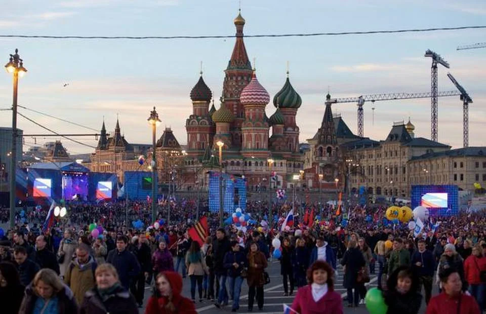 People leave after a rally marking the one-year anniversary of the annexation of Ukraine’s Crimea Peninsula, outside the Kremlin, with St. Basil Cathedral in the background, in Moscow on Wednesday. A new Russian state television documentary about the Crimean crisis features President Vladimir Putin raising the specter of using nuclear weapons to defend Russia’s interests, effectively daring the West to risk nuclear war by supporting or intervening in Ukraine. Denis Tyrin The Associated Press