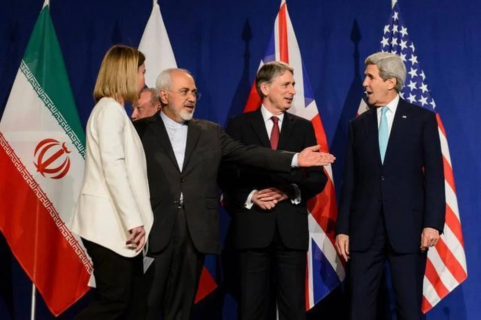This round of nuclear talks with Iran was conducted in American English under the guidance of U.S. Secretary of State John Kerry, right, a Yale graduate, and Iran’s Foreign Minister Mohammad Javad Zarif, second from left, who graduated from San Francisco State and the University of Denver. Jean-Christophe Bott Keystone