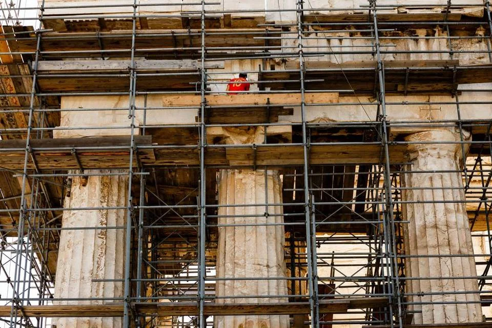 A man works at the Parthenon on Acropolis Hill in Athens, Greece, on Wednesday. | Daniel Ochoa de Olza Associated Press