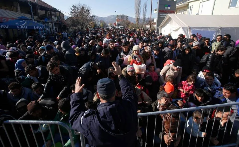 A police officer organizes a throng queuing to get registered at a refugee center in the southern Serbian town of Presevo. Middle East refugees should be invited to join a new military force and given the training, resources and support needed to defeat Islamic State and liberate their homelands. Darko Vojinovic The Associated Press