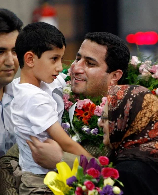 In this 2010 photo, Shahram Amiri, an Iranian nuclear scientist greets his son Amir Hossein as he arrives at the airport in Tehran, after returning from the United States. Amiri, who was caught up in a real-life U.S. spy mystery and later returned to his homeland, was executed under mysterious circumstances. Amiri was hanged recently. Vahid Salemi Associated Press file.