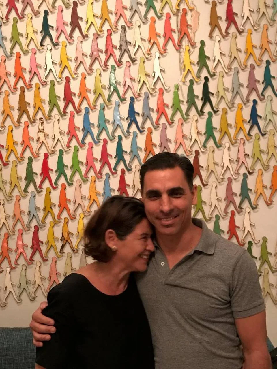 Internationally known Cuban artist Damian Aquiles and his American wife, Pamela Ruiz, stand in front of his “Walking Men” work, which was also commissioned by the Council on Foreign Relations office in Washington, D.C. Evolving political change in Cuba is giving artists and budding entrepreneurs a glimpse at new opportunities. - Markos Kounalakis