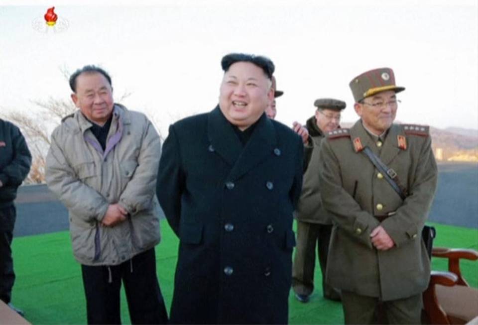 In this images made from video released by KRT on March 7, North Korean leader Kim Jong Un, center, reacts during the launch of four missiles in an undisclosed location North Korea. Kim Jong-un has likely taken the storyline of a movie about him and twisted it to kill his half brother.