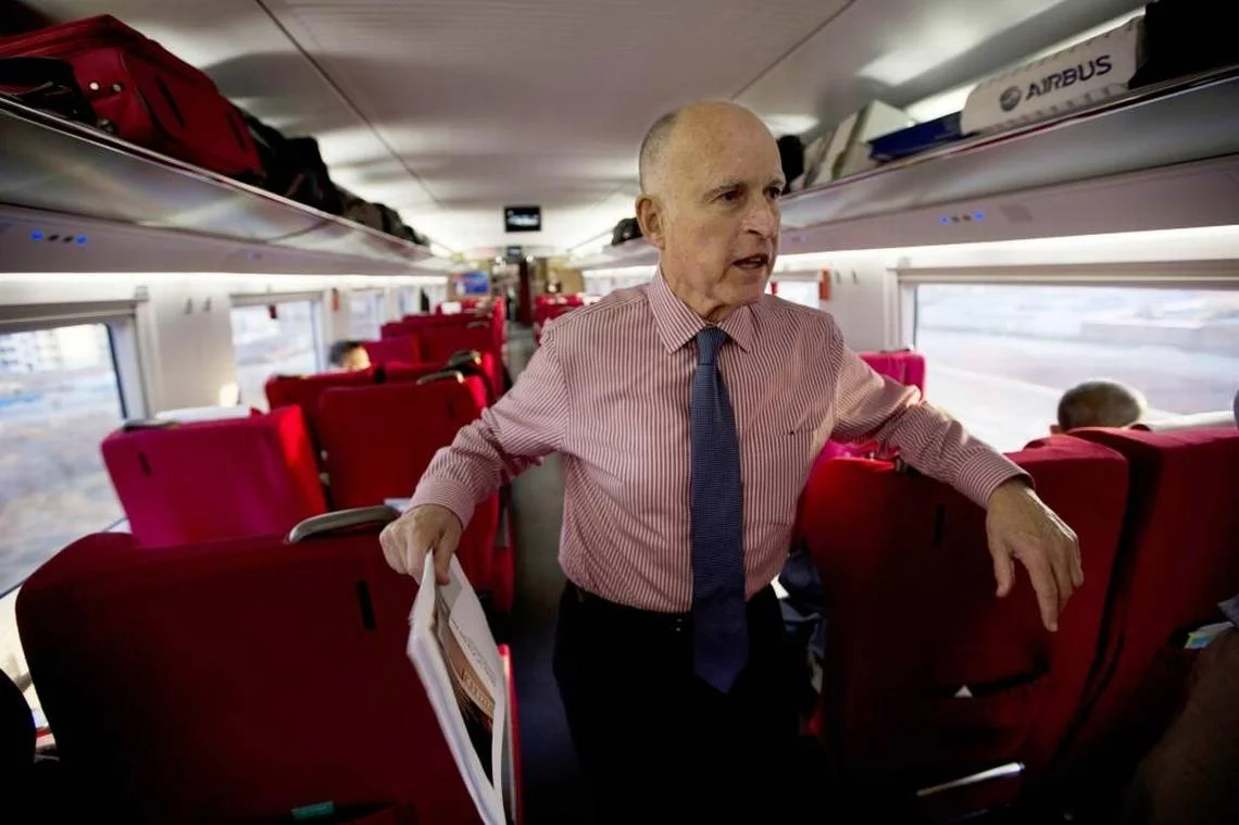 California Gov. Jerry Brown speaks to journalists on board a high speed rail leaving from the Beijing South train station during his last trip to China in 2013. Ng Han Guan ASSOCIATED PRESS