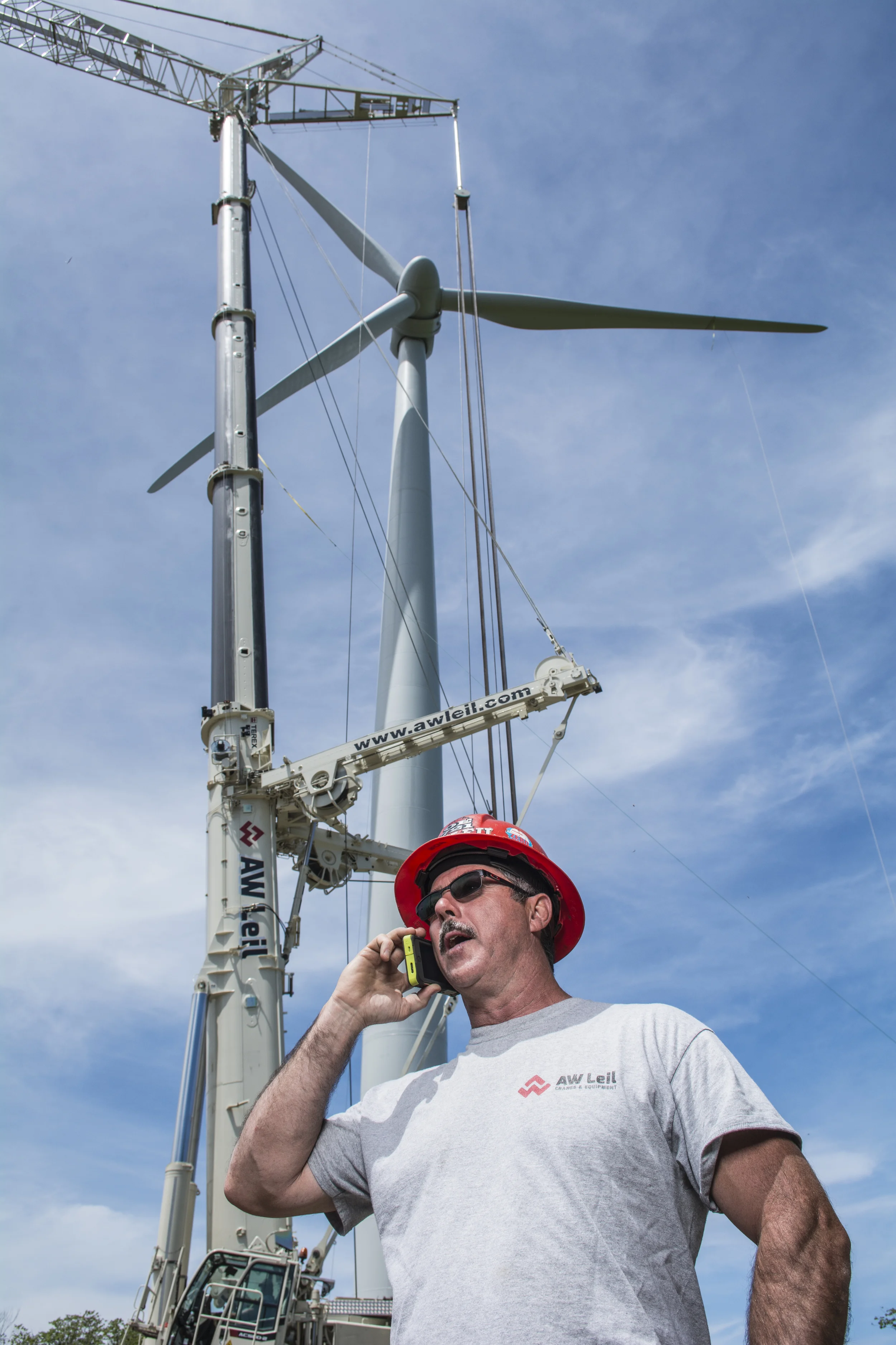 A.W. Leil Cranes & Equipment - Operator in front of crane & turbine