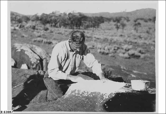 C. P. Mountford, anthropologist, photographed working on location at Panaramitee, South Australia.