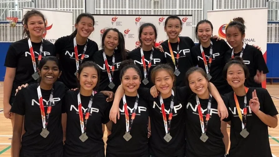Angelin Sng (top row, third from left) with her netball team members