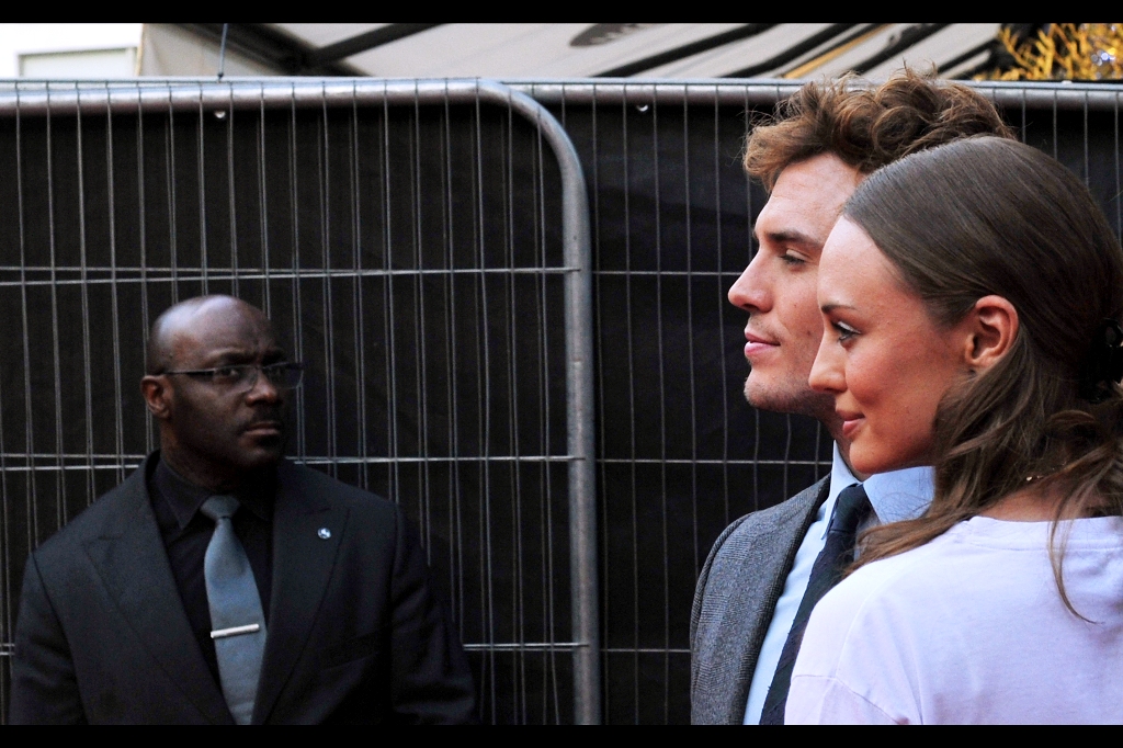 Sam Claflin and actress/wife Laura Haddock pose for the engraver who'll be releasing a newly minted coin in their honour. Laura Haddock is best know for being in The Inbetweeners movie, and also apparently as "Autograph Seeker" in the first Captain America movie.