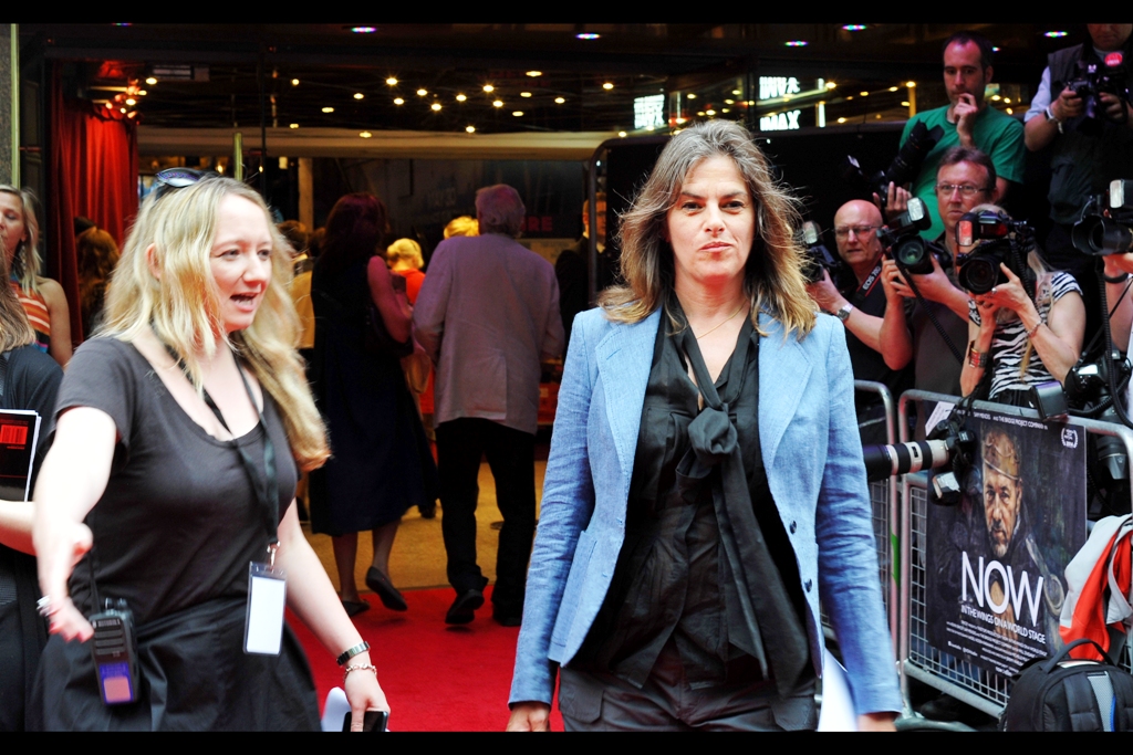I think she's a singer and she's not affiliated with the film. So that should narrow it down... Edited to add : she's actually artist Tracey Emin, whose (unmade) work 'my bed' was shortlisted for the 1999 Turner prize and was bought by Charles Saatchi £150,000 and is currently on sale...