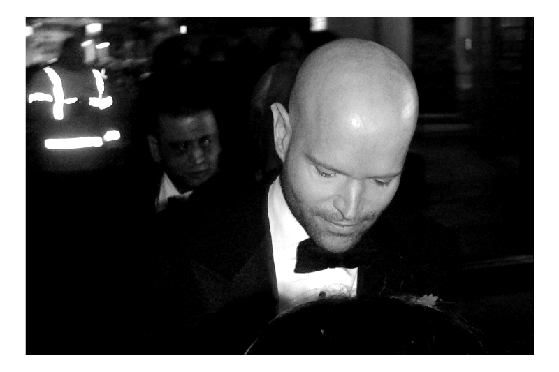 People were saying "He's the bad guy" but I found it hard to tell whether people were talking about him or the character he may play in the movie. Still, if somebody gives you a piece of paper at a premiere, you're entitled to sign it. (Edited to add : People were wrong : he's Marc Forster - the director of the film) (then again... with the benefit of hindsight, with this movie widely criticised for being a sub-par Bond film, People Might Not Have Been So Wrong)