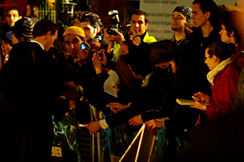 He's a Guy and he wears a Yellow Cap. That's why he's called Yellow Cap Guy, and for tonight he got himself pole position, and look: a celebrity to pose with. Once again, well played, sir.