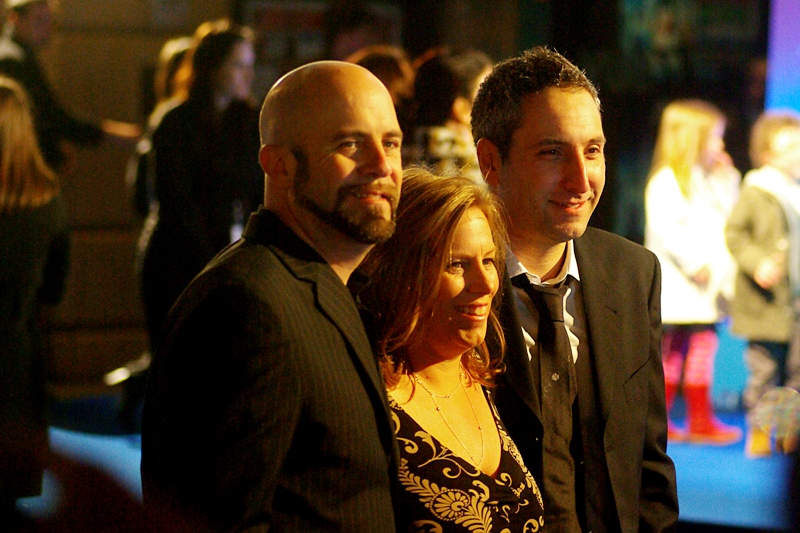 Two of the directors (Conrad Vernon and Rob Letterman) and a producer (Lisa Stewart) share a laugh in front of the Paparazzi. Or... well... two half-smiles and a quarter-smirk.
