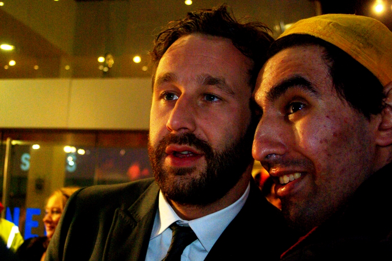 Actor Chris O'Dowd looks unsure in the presence of Yellow Cap Guy. Don't we all?