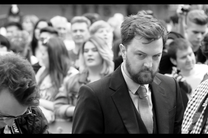 Damon Beesley keeps watch, like Gotham's better dressed and more publicly visible guardian. Or maybe he's just wondering what three guys in their *cough* thirties are doing in a pen otherwise filled with people in their late teens and early twenties. And primarily female.