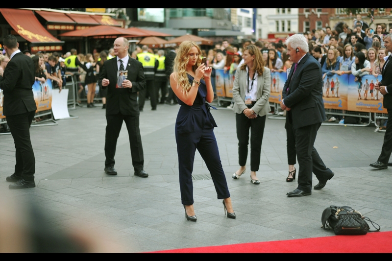 Fiitingly for this premiere, I also have no idea who this is. But I'll concede I don't pose quite this coolly and sophisticatedly when taking a photo of a friend being photographed by the paparazzi (on the rare occasions that this happens)