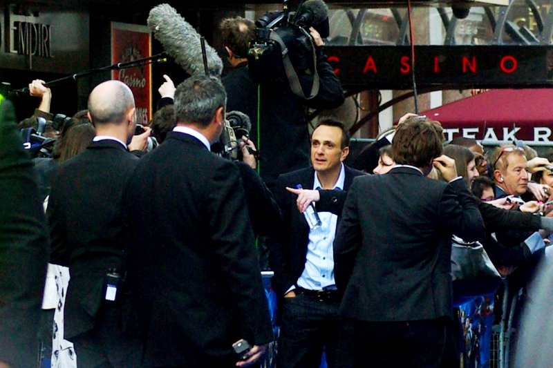 Hank Azaria has had a fairly long and meritorious list of acting credits, often in smaller roles. For instance 'Pretty Woman' and 1998's 'Godzilla'. But his list of voice credits for The Simpsons bears mentioning : Bartender Moe Szyslak, Comic Book Guy, Carl Carlson, Cletus, Professor Frink, Dr. Nick Riviera, Lou, Snake, Kirk Van Houten, the Sea Captain, Superintendent Chalmers, Disco Stu, and Duffman. ( "Duffman says... awesome" )