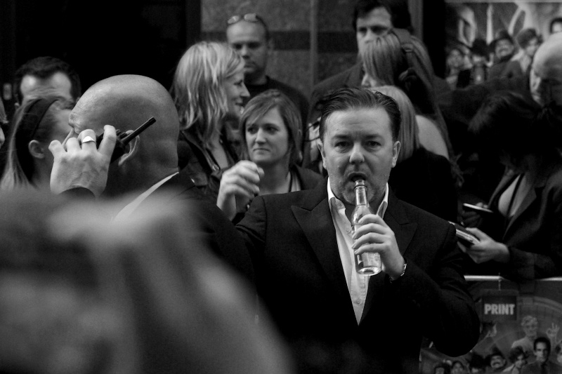 Ricky Gervais. Surprisingly likely to break into song at random moments, microphone in hand or not..