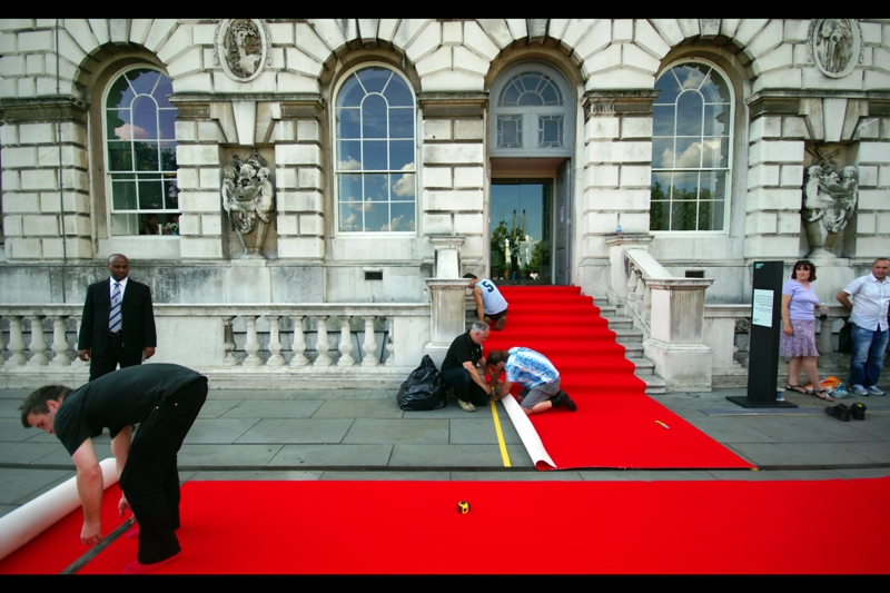 In the end, the organisers allowed for fans to crowd along a double-file row along the columns to the back and left (out of view). What this meant was that the queue was two wide and about six deep, and blocked by security. I've seen worse organisation, but it usually involved either a riot or a plot device by an incompetent screenwriter.